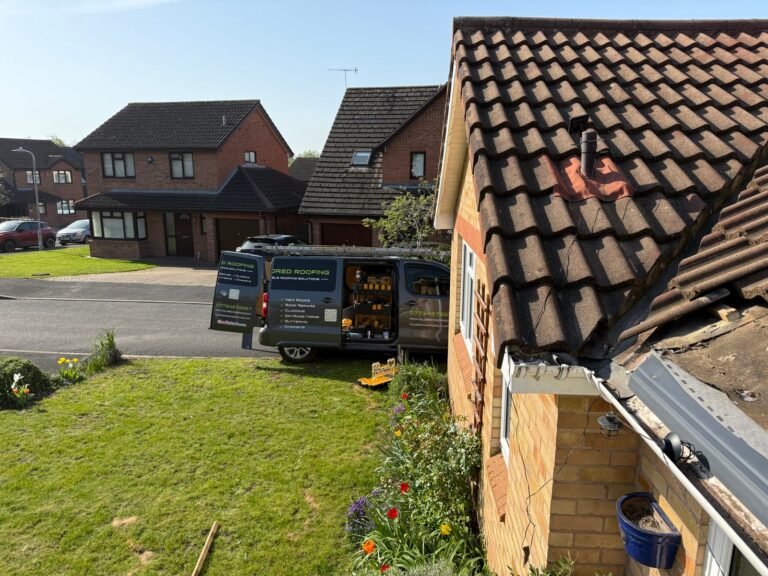 Tiled roof and guttering beside a residential garden