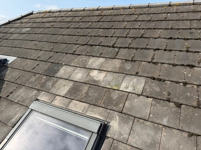 Slate roof with a rooflight and repaired covering