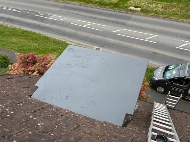 Small flat roof adjoining a tiled roof
